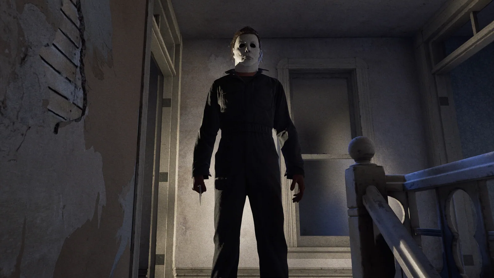 Michael Myers standing at the top of an interior staircase with a knife