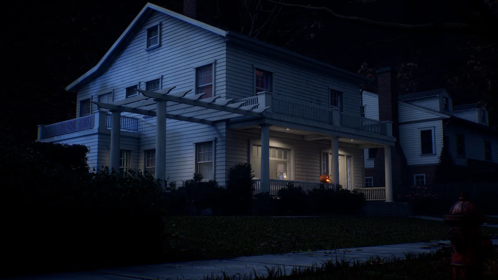 The wide two-story Wallace residence at night in Orange Grove Estates